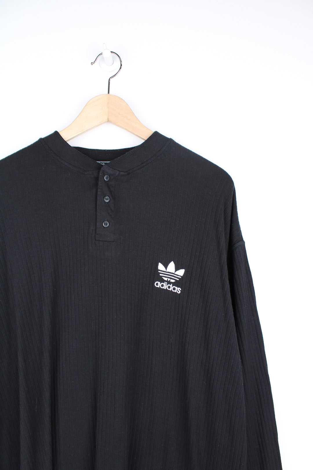 Adidas Long Sleeved Shirt in a black colourway, knitted cotton, quarter button up, and has the logo embroidered on the front.