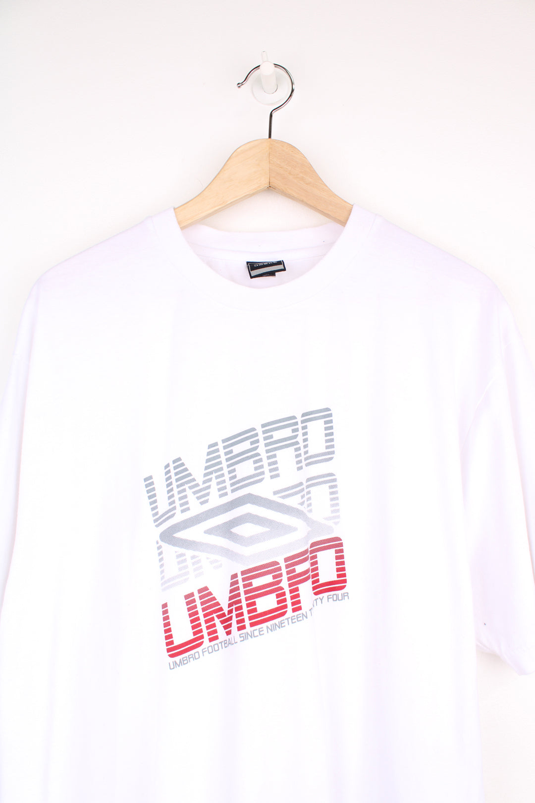 Umbro T-Shirt in a white colourway, short sleeve crewneck, and has logo spell out printed on the front.