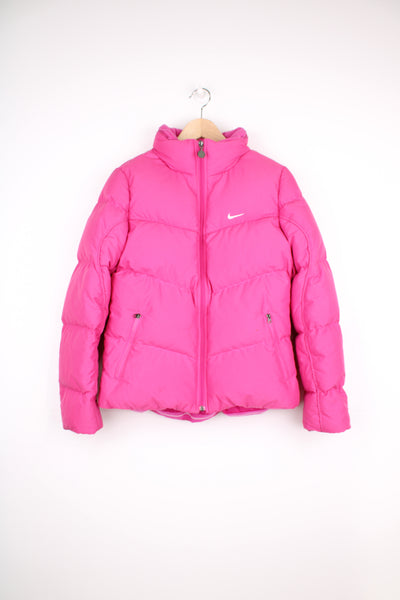 2000's pink Nike puffer jacket with embroidered swoosh logo on the chest and zip up pockets