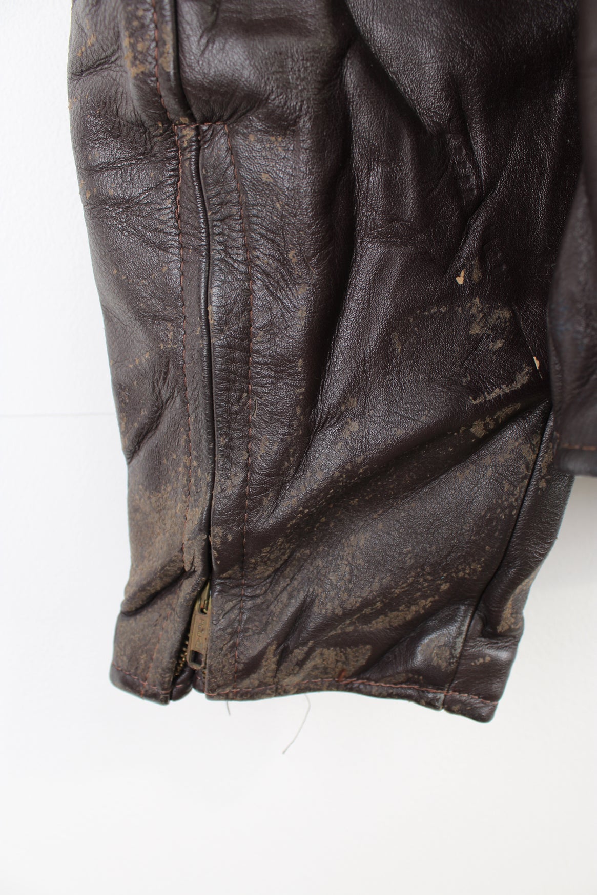 Vintage Leather Biker Jacket in a brown colourway, zip up with side pockets, and has a nylon lining.