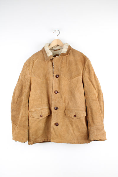 Vintage 70's Schott Bros Rancher Suede Coat in a tan colourway, sherpa lining, button up with big collar, and has side pockets.