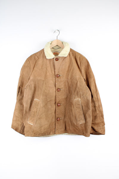 Vintage Suede Coat in a tan colourway with a sherpa lining, button up with a big collar, side pockets and has contrast stitching throughout.