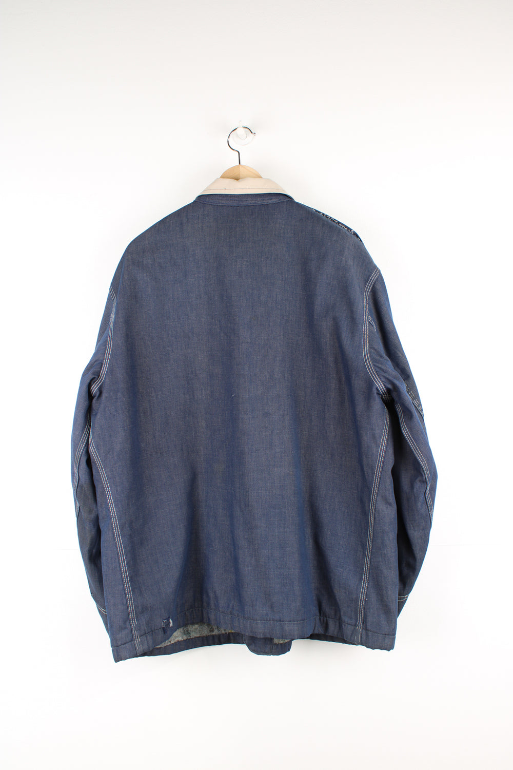 Vintage 70's Lee Denim Chore Jacket in a dark blue colourway with a tanned collar and contrast stitching throughout, button up with multiple pockets, blanket lining, and has the logo embroidered on the front.