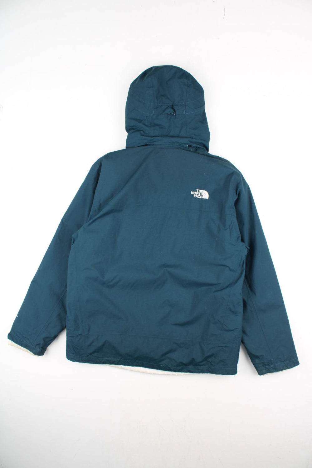 The North Face 2 in 1 Dryvent Jacket in a blue colourway. Zips up and has multiple pockets, detachable gilet lining, hooded, and has the logo embroidered on the front and back.