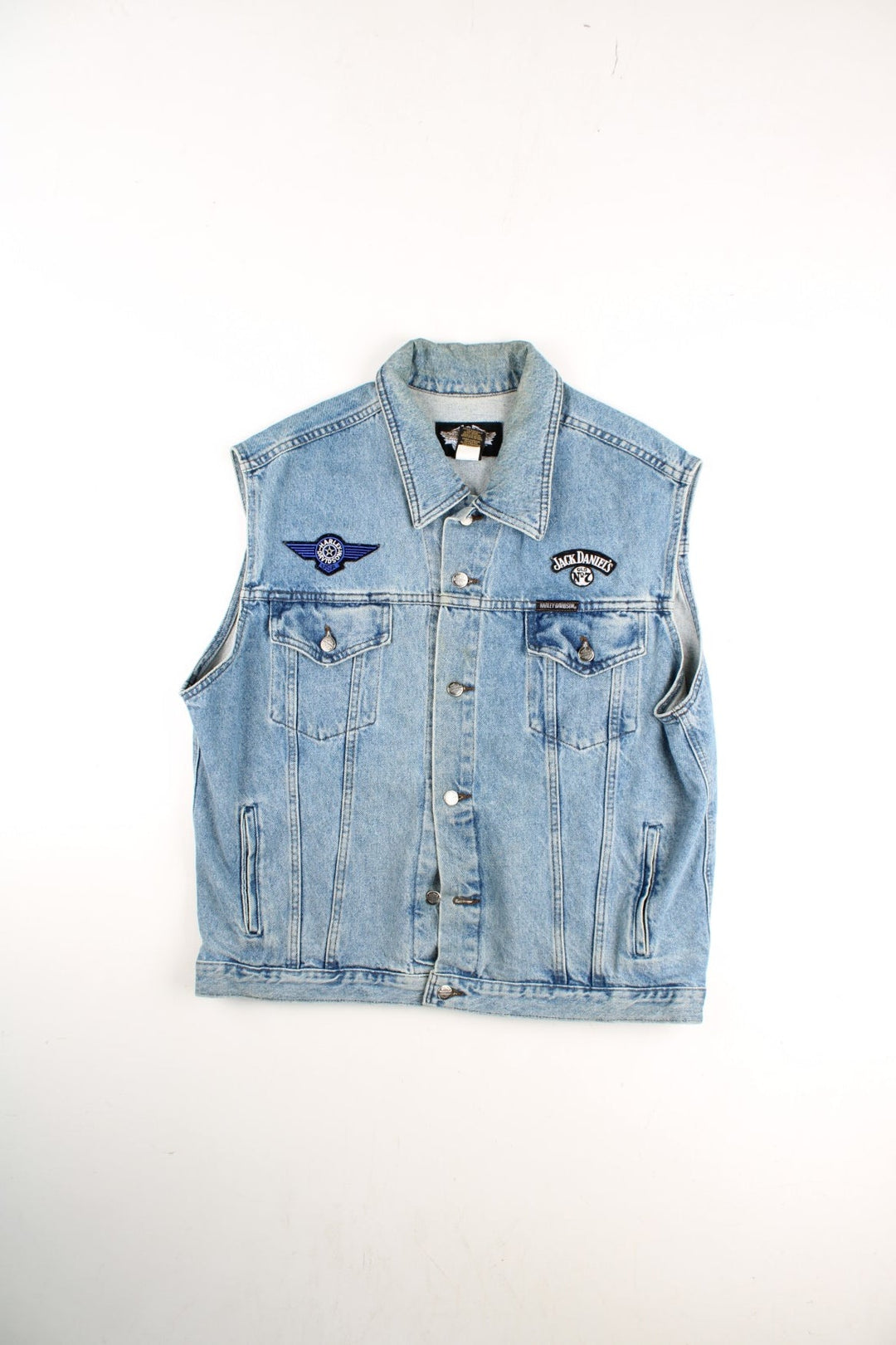 Vintage Harley-Davidson Denim Vest in a blue colourway. Buttons up and has multiple pockets, and the logo badges embroidered on the front and back.