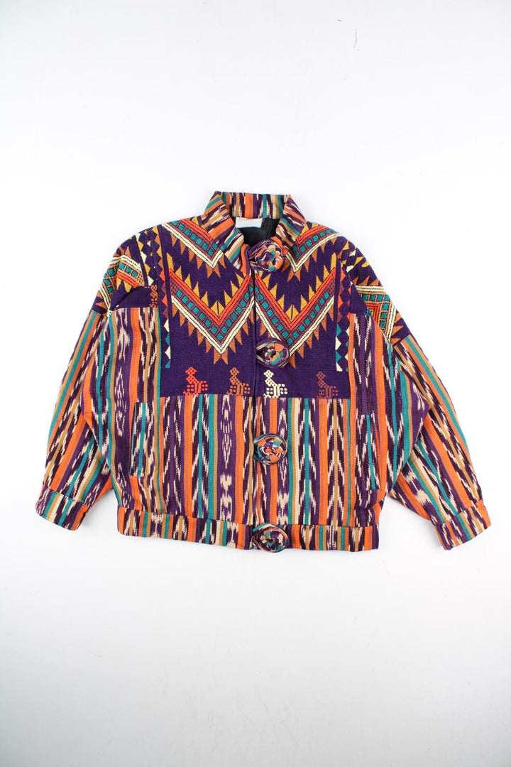 Vintage Aztec Patterned Jacket in a multicoloured colourway. Zips and buttons up with big buttons on the front, and has side pockets.