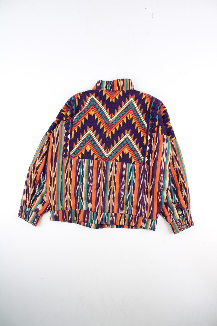 Vintage Aztec Patterned Jacket in a multicoloured colourway. Zips and buttons up with big buttons on the front, and has side pockets.