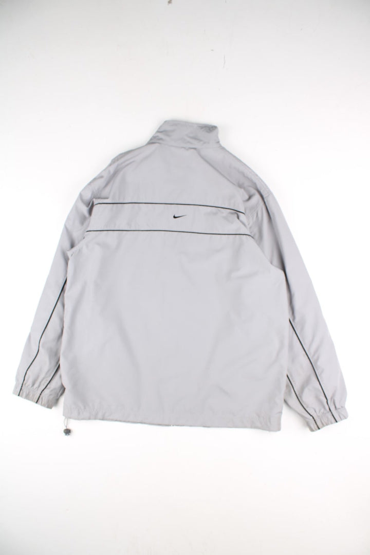 Y2K Nike Tracksuit Jacket in a grey colourway. Zips up and has side pockets, mesh lining, and has the swoosh logo embroidered on the front and back.