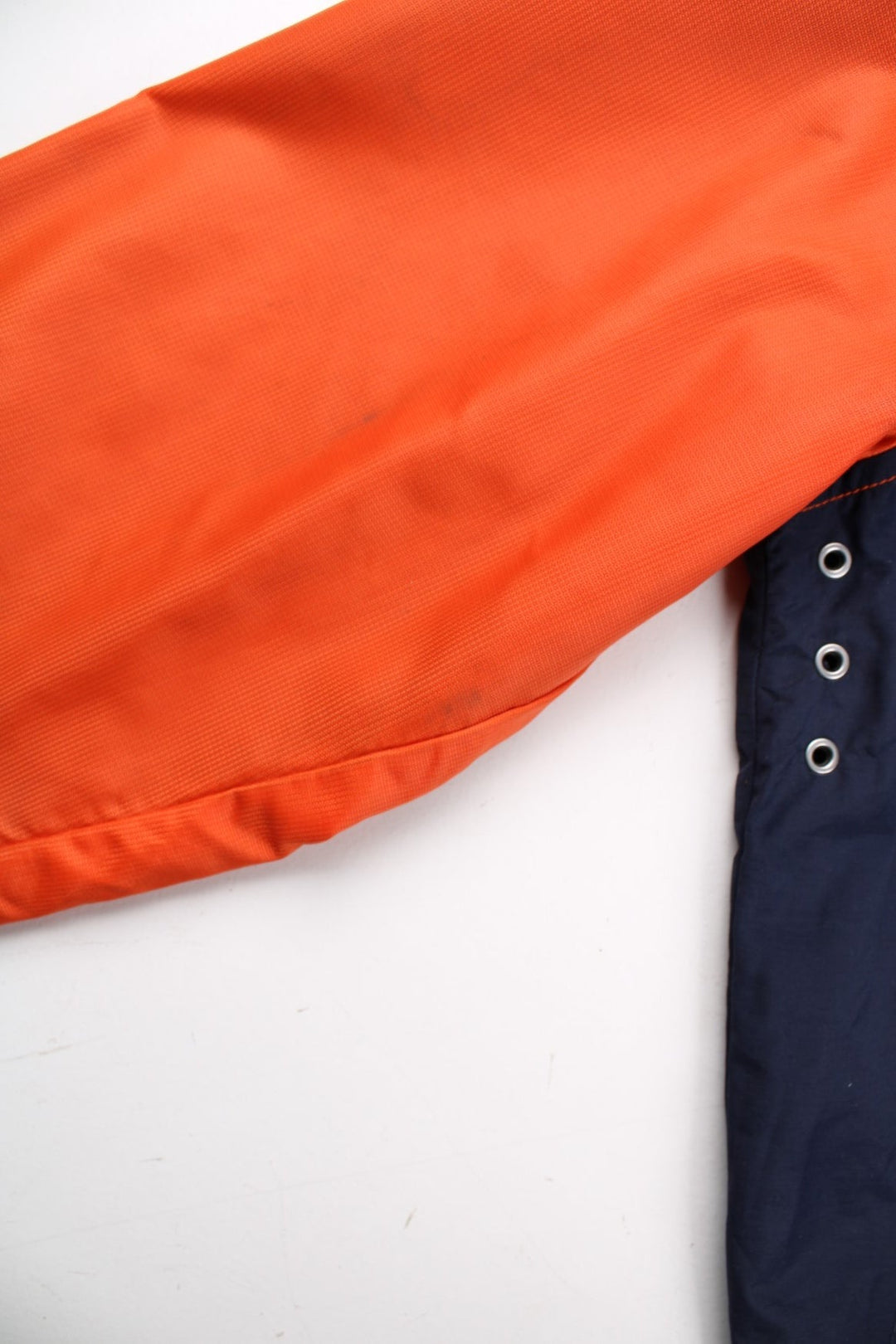 Vintage Tommy Hilfiger Windbreaker Jacket in a orange and blue colourway. Zips up and has side pockets, mesh lining, has the logo stripe going across the front and back, and the spell out embroidered on the left sleeve.