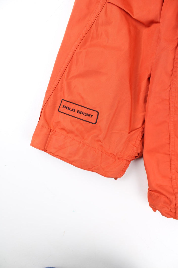 Vintage Polo Sport Ralph Lauren Mountain Parka Coat in a orange colourway. Zips up and has side pockets, insulated with a detachable fleece lining, hooded, and has the logo embroidered on the cuff of the left sleeve.