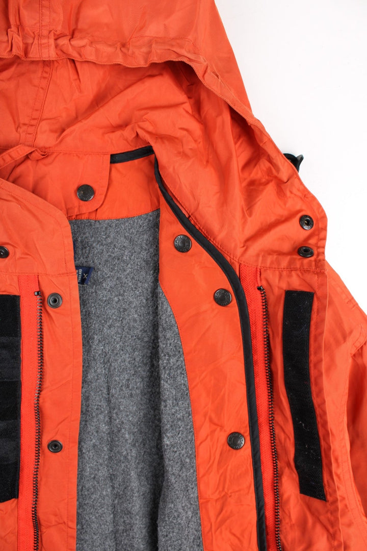 Vintage Polo Sport Ralph Lauren Mountain Parka Coat in a orange colourway. Zips up and has side pockets, insulated with a detachable fleece lining, hooded, and has the logo embroidered on the cuff of the left sleeve.