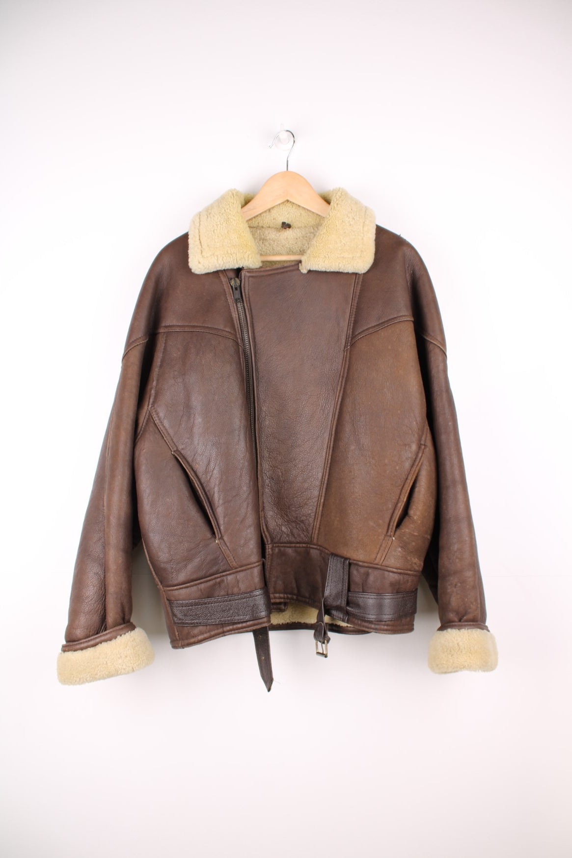 Vintage shearling aviator sheepskin jacket. Features buckle belt on the waist.