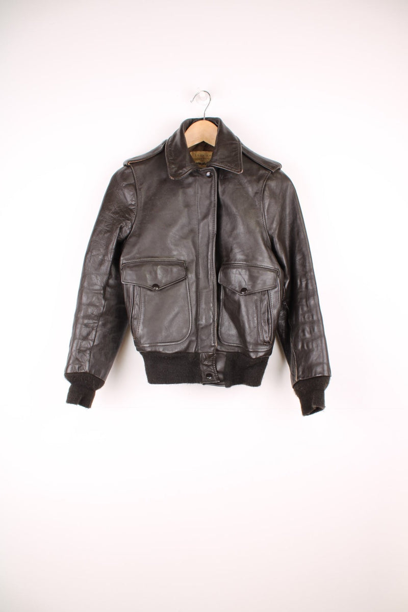 Vintage Schott brown leather flight jacket. Features zip and popper fastenings and double pockets.