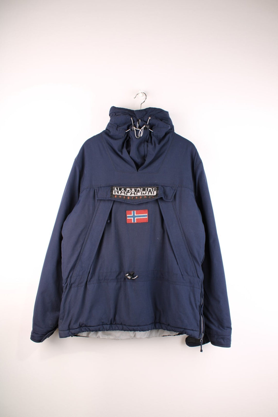 Napapijri Geographic hooded pullover in navy blue with quilted lining, multiple pockets, toggle adjusters, and a side zip.