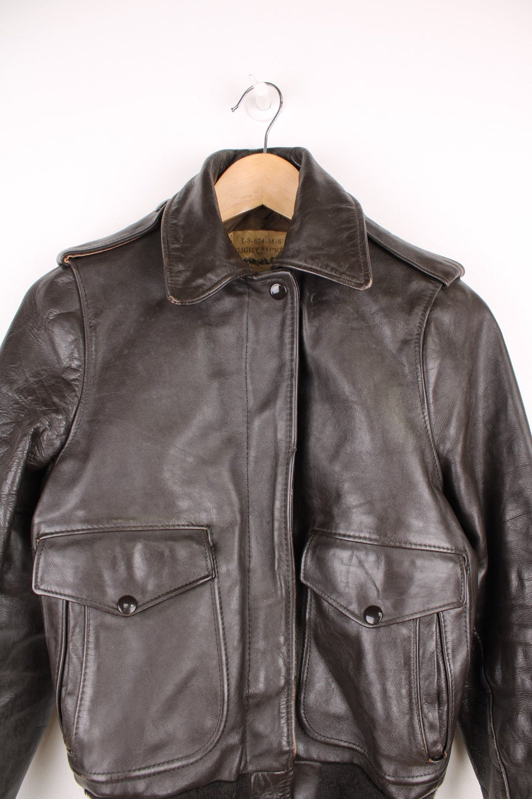 Vintage Schott brown leather flight jacket. Features zip and popper fastenings and double pockets.