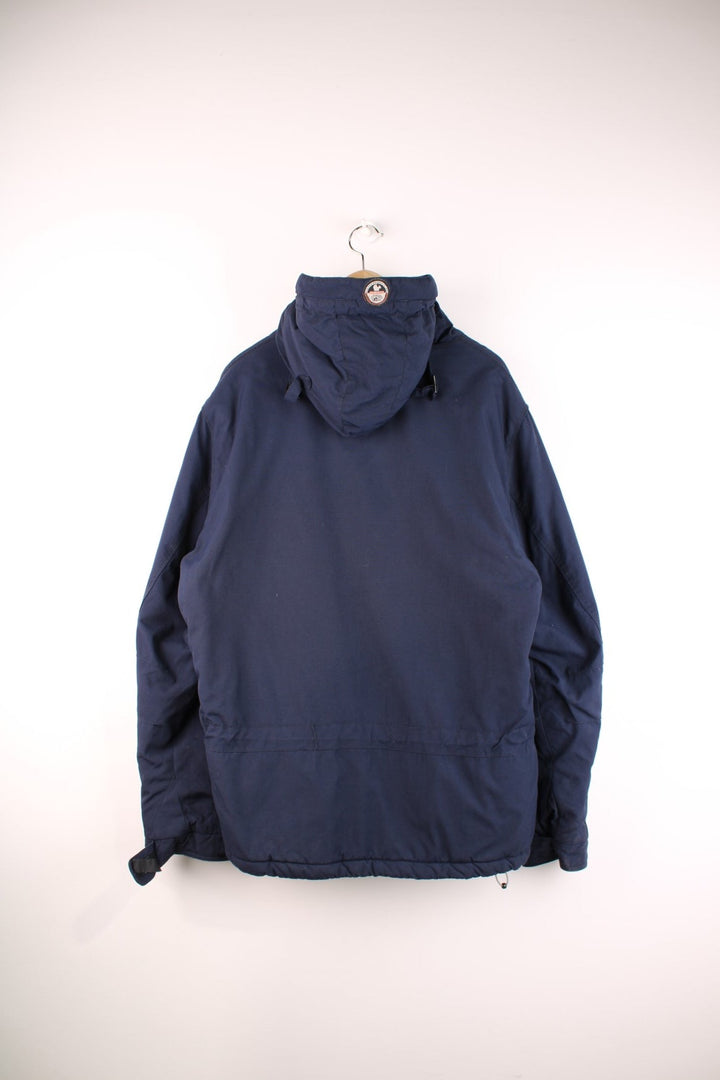 Napapijri Geographic hooded pullover in navy blue with quilted lining, multiple pockets, toggle adjusters, and a side zip.