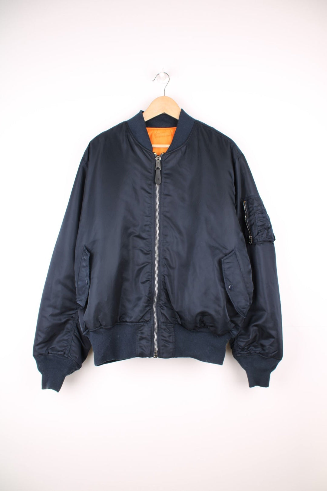 Alpha Industries MA-1 bomber flight reversible jacket in navy blue and orange with elasticated waistband and cuffs.