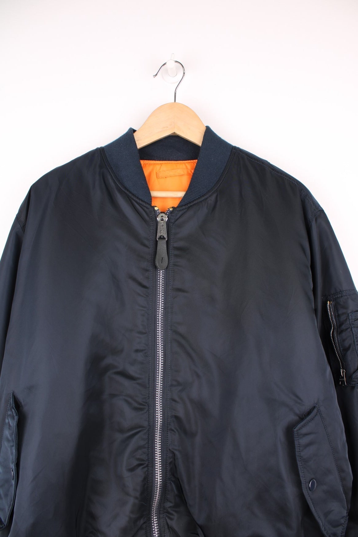 Alpha Industries MA-1 bomber flight reversible jacket in navy blue and orange with elasticated waistband and cuffs.