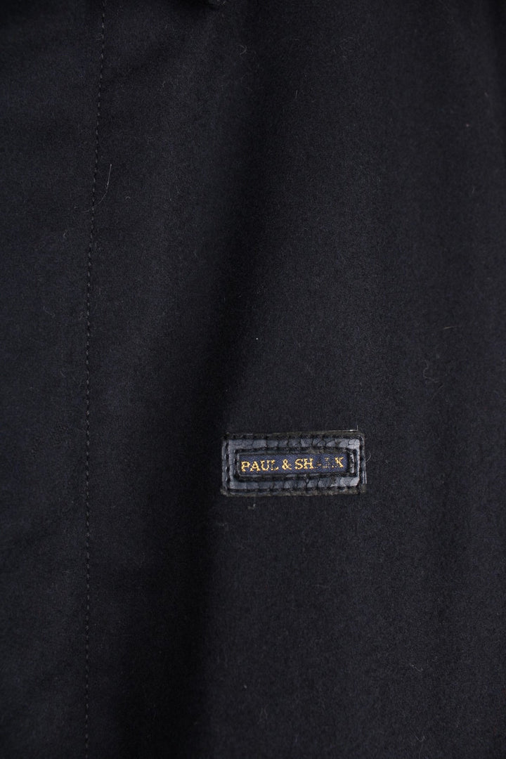  harrington jacket in a navy  colourway. The jacket has the Paul & Shark logo stitched on the front which is slightly worn as seen in the photos, it has a zip closure and is lined. The interior pockets have zips and there is a patch pocket for a small device or pen. 