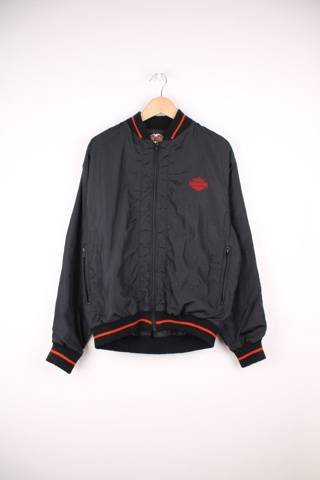 Vintage Harley Davidson shell/bomber jacket in black and orange. Features orange embroidered logo on the chest and spell out logo across the back.