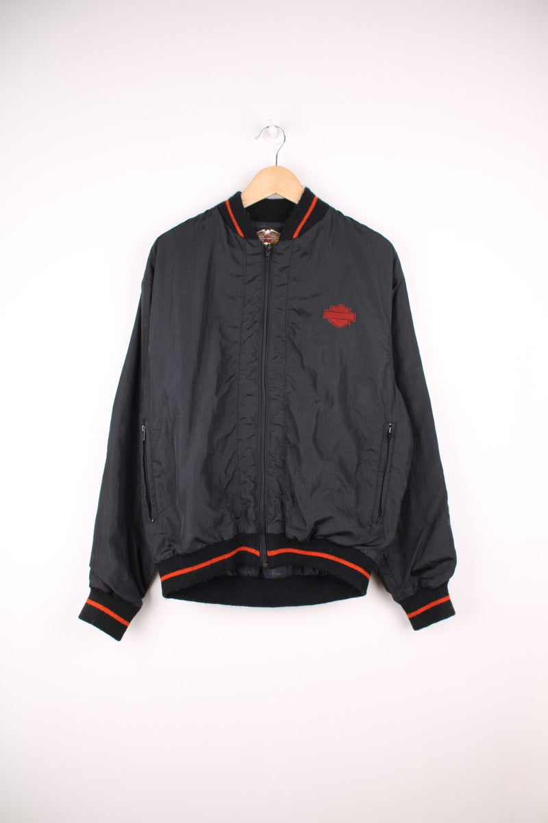 Vintage Harley Davidson shell/bomber jacket in black and orange. Features orange embroidered logo on the chest and spell out logo across the back.