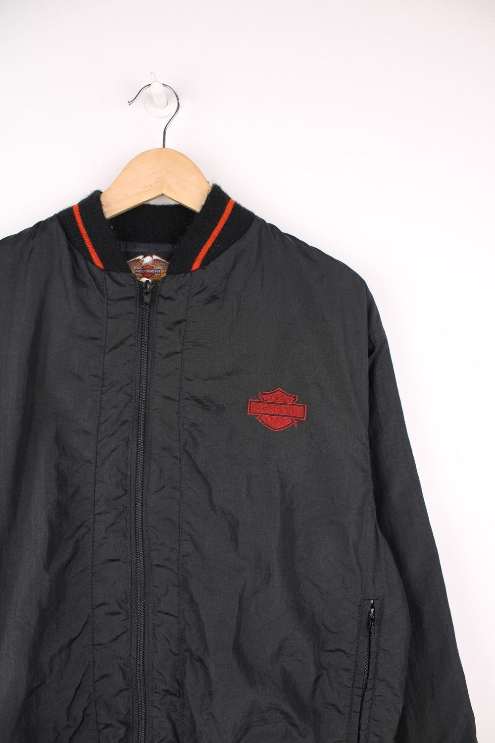 Vintage Harley Davidson shell/bomber jacket in black and orange. Features orange embroidered logo on the chest and spell out logo across the back.