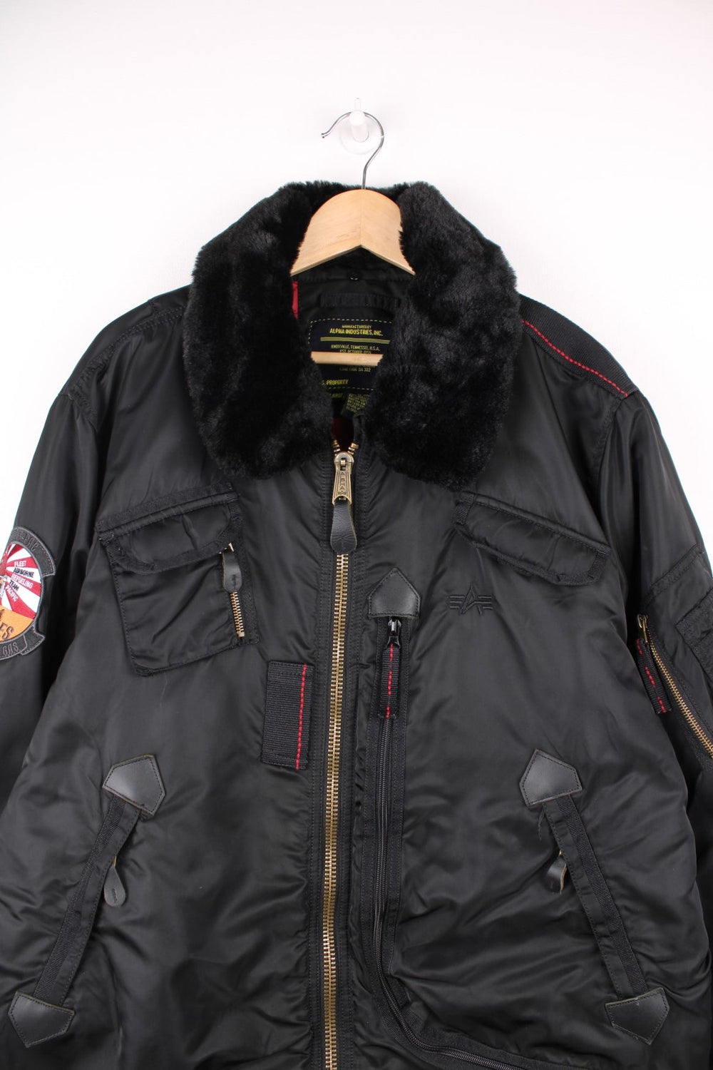 Vintage Alpha Industries bomber jacket with fur collar, multiple pockets and embroidered badge on the sleeve.