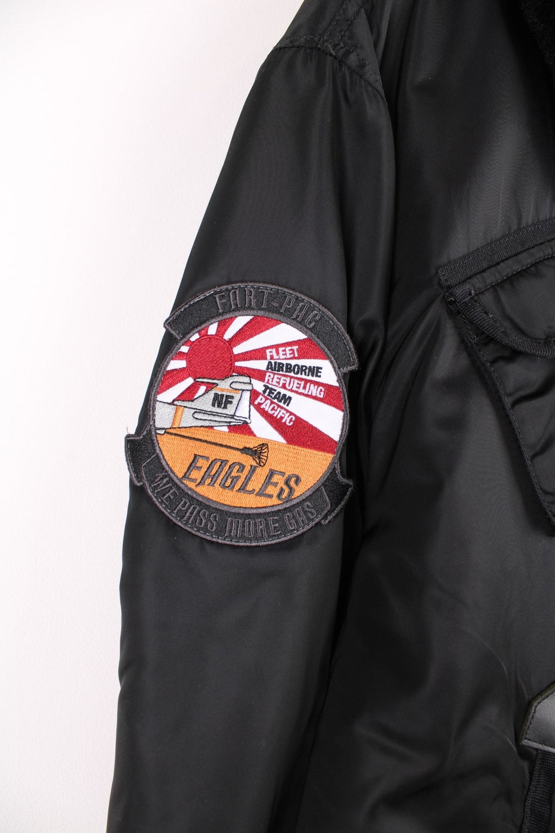 Vintage Alpha Industries bomber jacket with fur collar, multiple pockets and embroidered badge on the sleeve.