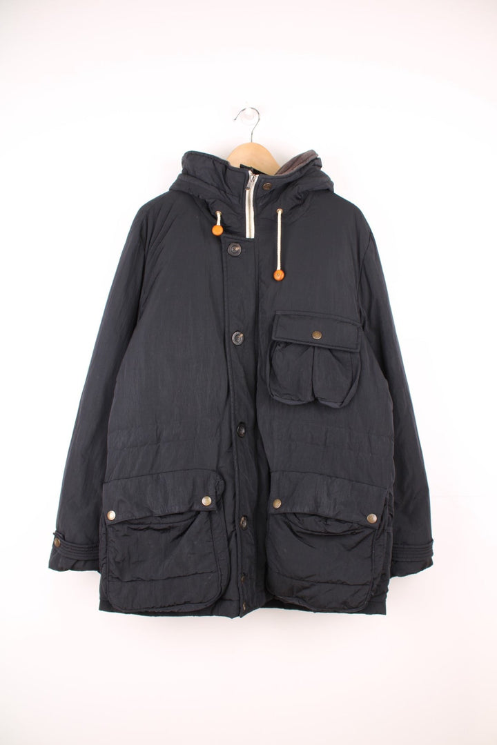 CP Company hooded down parka jacket with zip and button fastenings and multiple pockets.