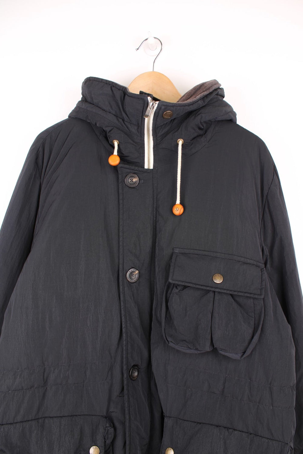 CP Company hooded down parka jacket with zip and button fastenings and multiple pockets.