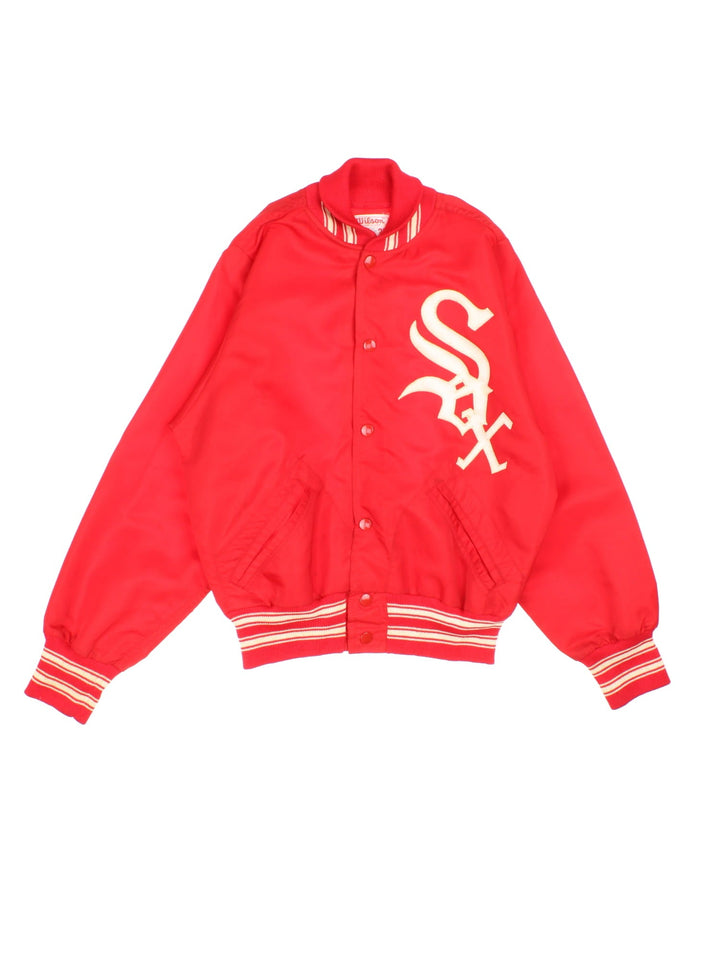 Vintage 1970s Wilson Chicago White Sox bomber jacket in a red colourway. The jacket has a large embroidered Red Sox Logo on the front. striped elasticated cuffs and hem, and two jetted pockets. Made in the USA. 