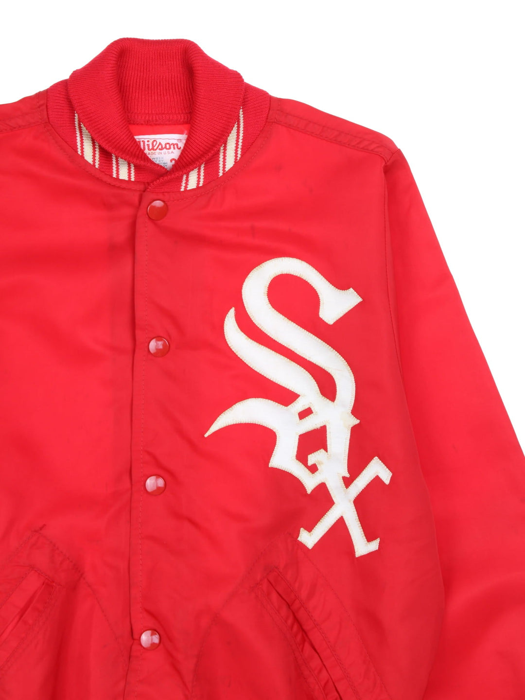 Vintage 1970s Wilson Chicago White Sox bomber jacket in a red colourway. The jacket has a large embroidered Red Sox Logo on the front. striped elasticated cuffs and hem, and two jetted pockets. Made in the USA. 