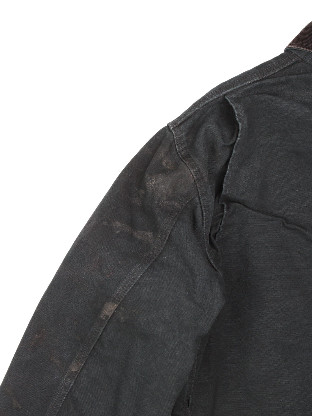  1990s Carhartt Chore jacket in a black colourway. The jacket has a corduroy collar, is blanket lined and has multiple pockets on the exterior and one on the interior. There is a stitched logo on the front pocket, and gold hardware. 