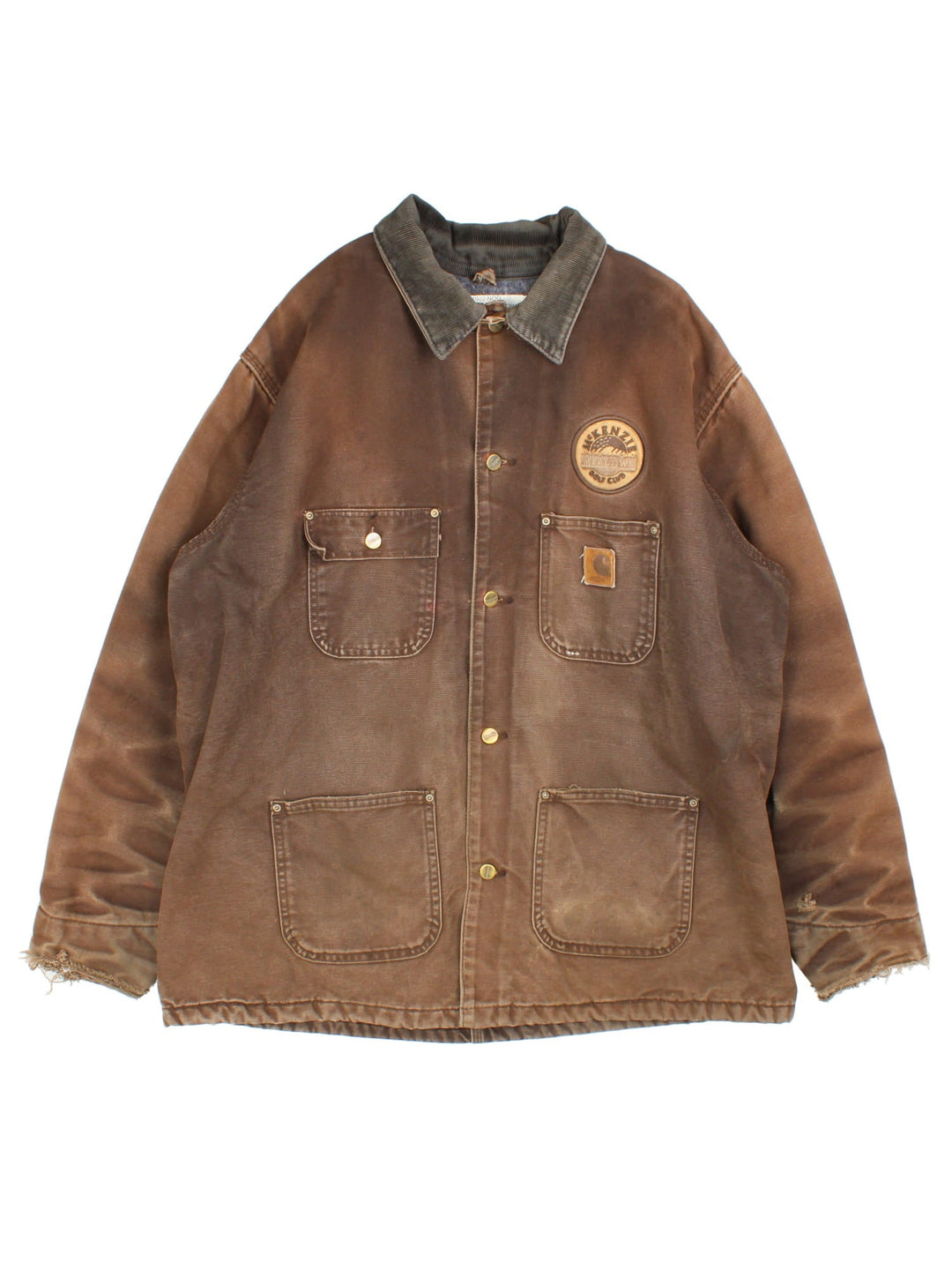 Vintage Carhartt Chore Coat in a brown colourway. The jacket has multiple exterior pockets, and one interior. It is blanket lined and has a corduroy collar. There is a leather logo patch stitched onto the front, and gold hardware.