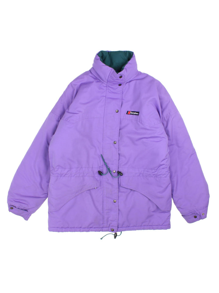 Vintage 1990s Berghaus Coat in a purple colourway. The jacket has two front pockets and one interior, a toggle to pull in the waist and a fold away hood.