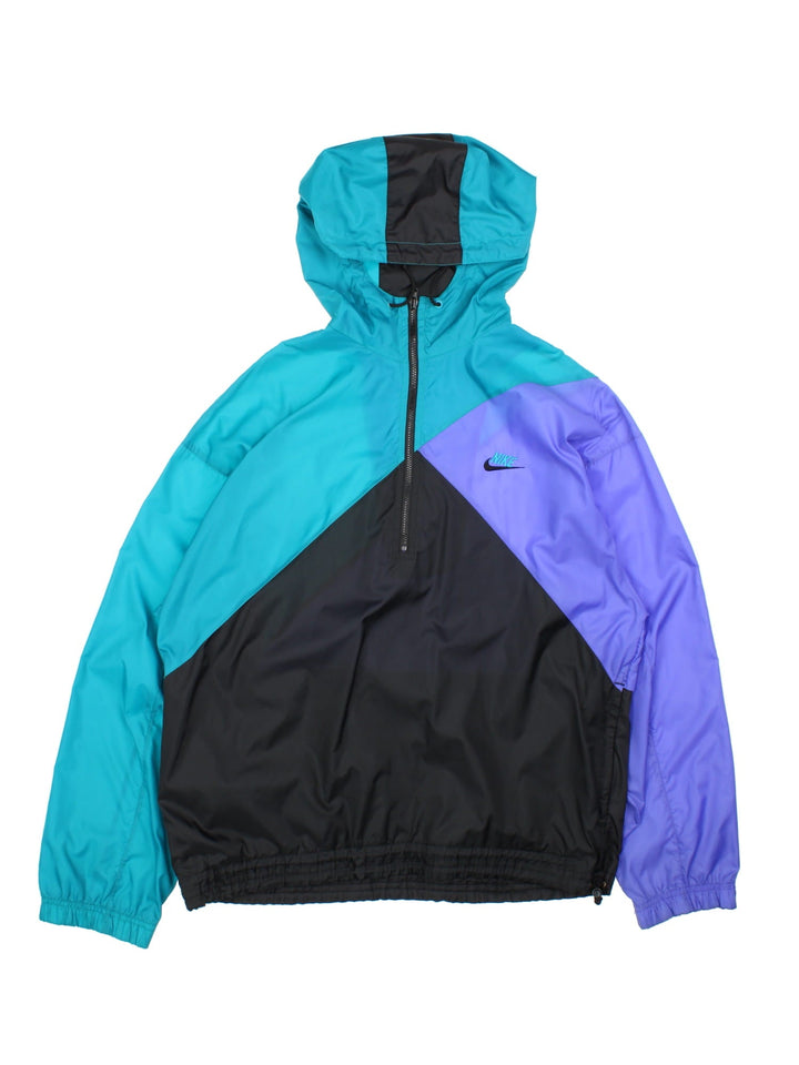 Vintage 1990s Nike 1/4 Zip Jacket in a black turquoise and purple colourway. The jacket has a small nike embroidered logo on the front and two side pockets.