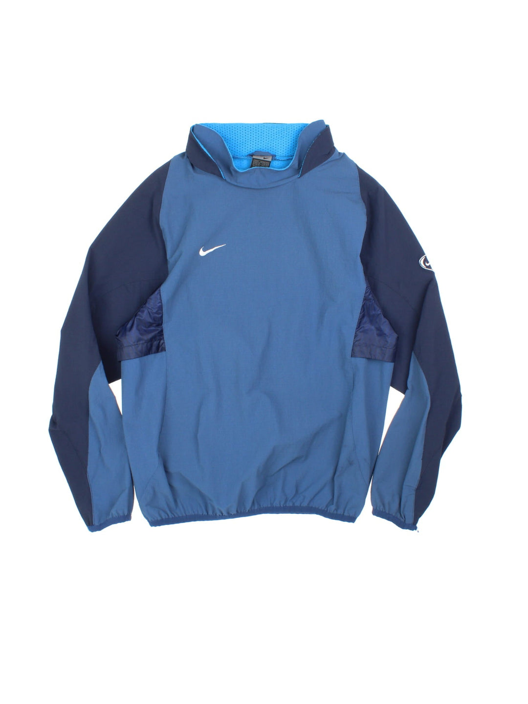 Vintage Y2K Nike long sleeve training top in a blue colourway. The top has panelled sleeves, a vent on the back, a double collar and elasticated cuffs and hem. 