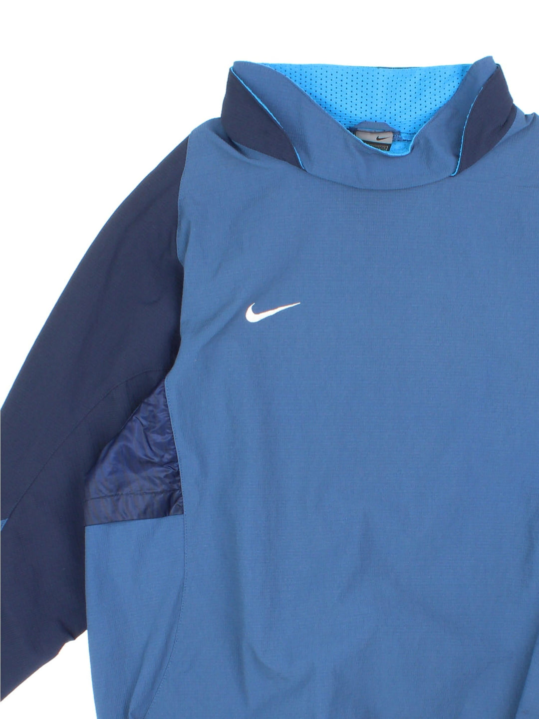 Vintage Y2K Nike long sleeve training top in a blue colourway. The top has panelled sleeves, a vent on the back, a double collar and elasticated cuffs and hem. 