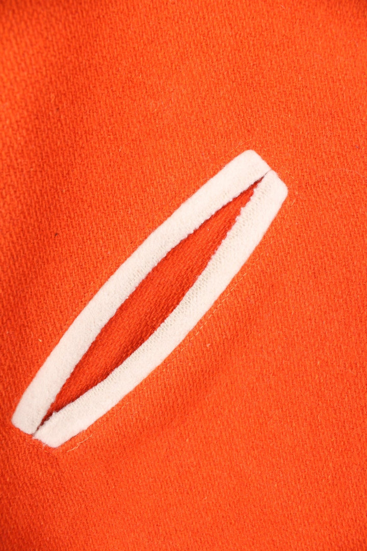 Vintage 70s Beavercreek orange wool varsity jacket. Features embroidered lettering on the back, and black and white stripe features on the cuffs and collar. 