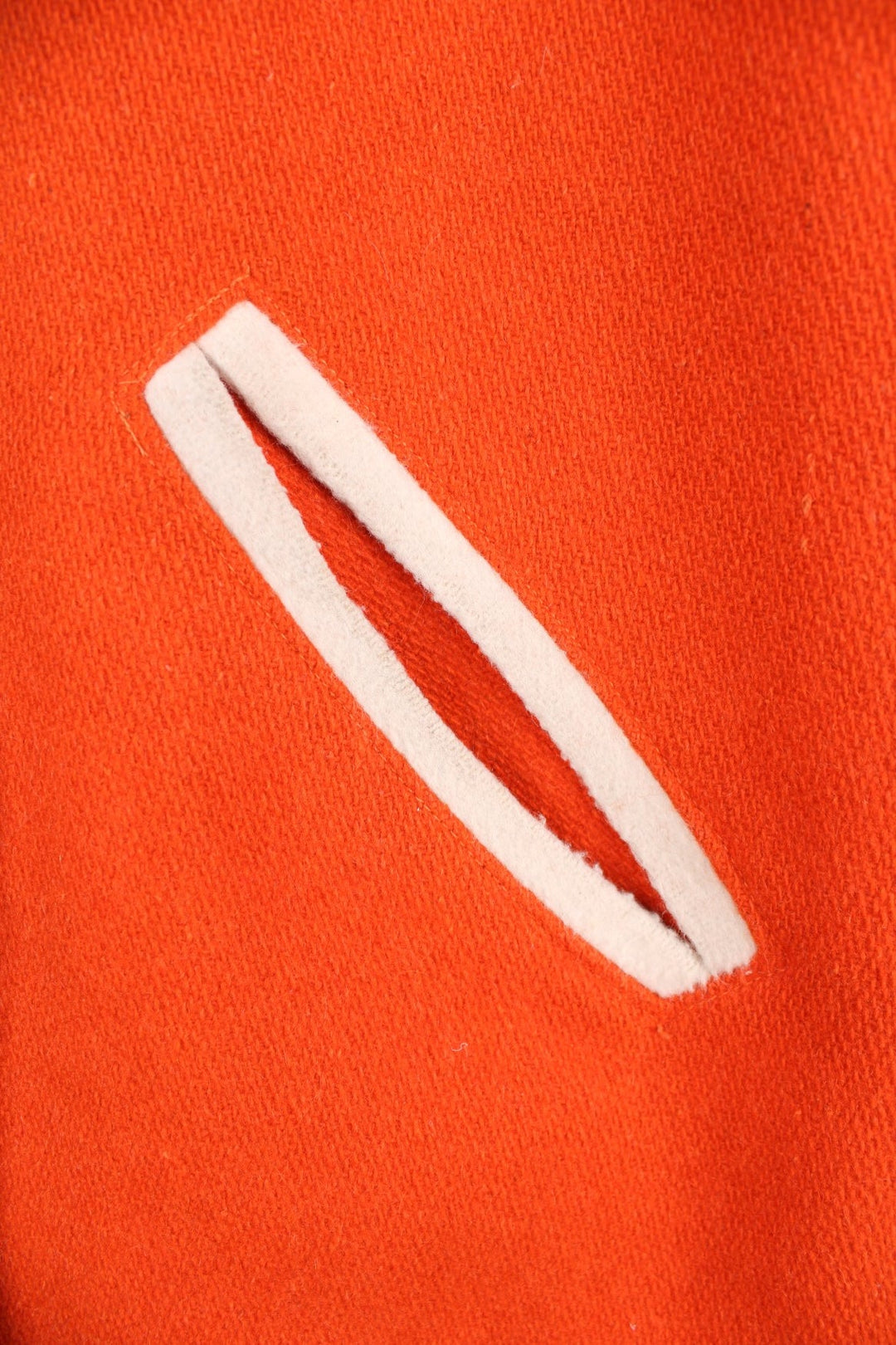 Vintage 70s Beavercreek orange wool varsity jacket. Features embroidered lettering on the back, and black and white stripe features on the cuffs and collar. 