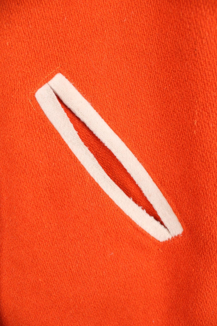 Vintage 70s Beavercreek orange wool varsity jacket. Features embroidered lettering on the back, and black and white stripe features on the cuffs and collar. 