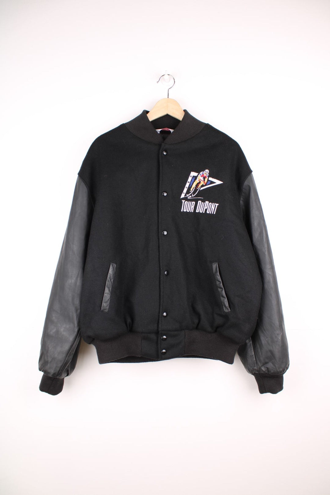 Vintage 1993 Tour DuPont black varsity jacket. Features embroidered logo on the front and back.