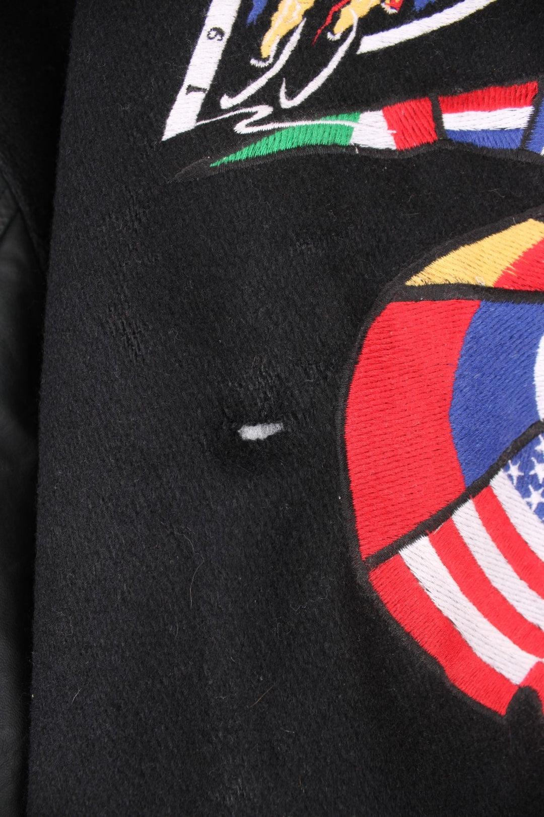 Vintage 1993 Tour DuPont black varsity jacket. Features embroidered logo on the front and back.