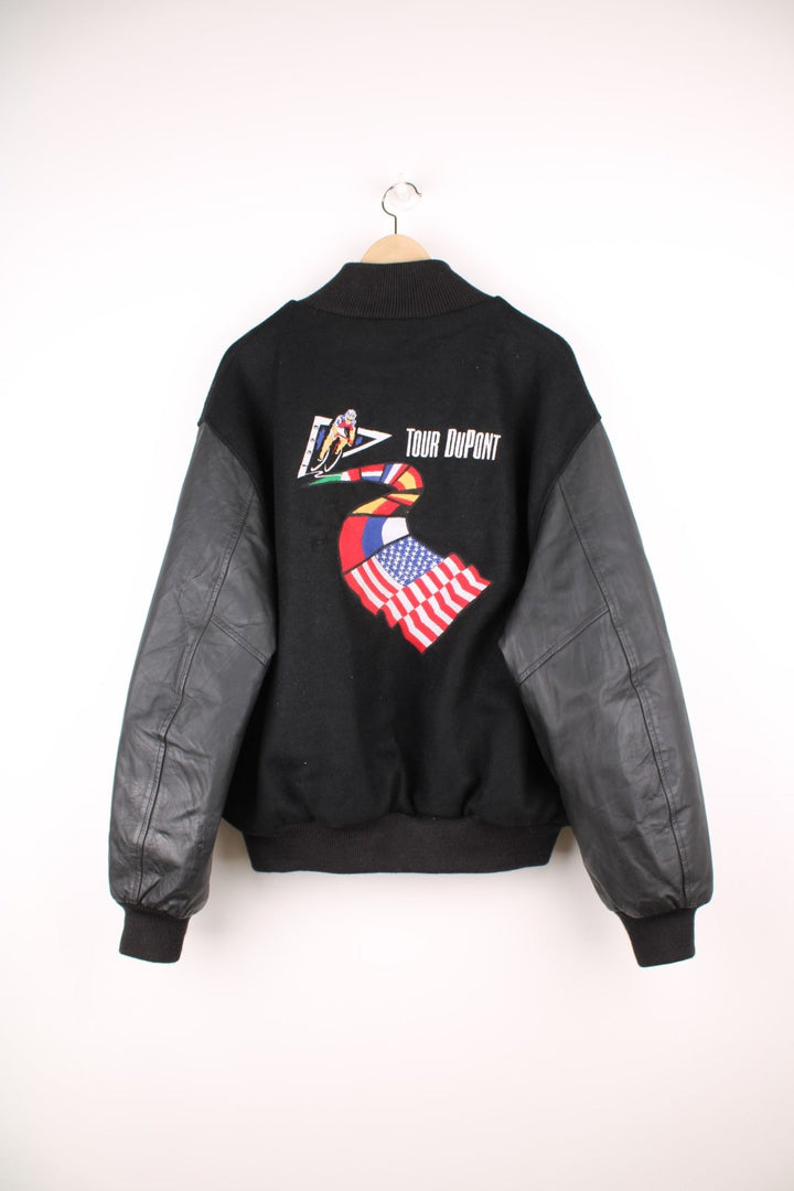 Vintage 1993 Tour DuPont black varsity jacket. Features embroidered logo on the front and back.