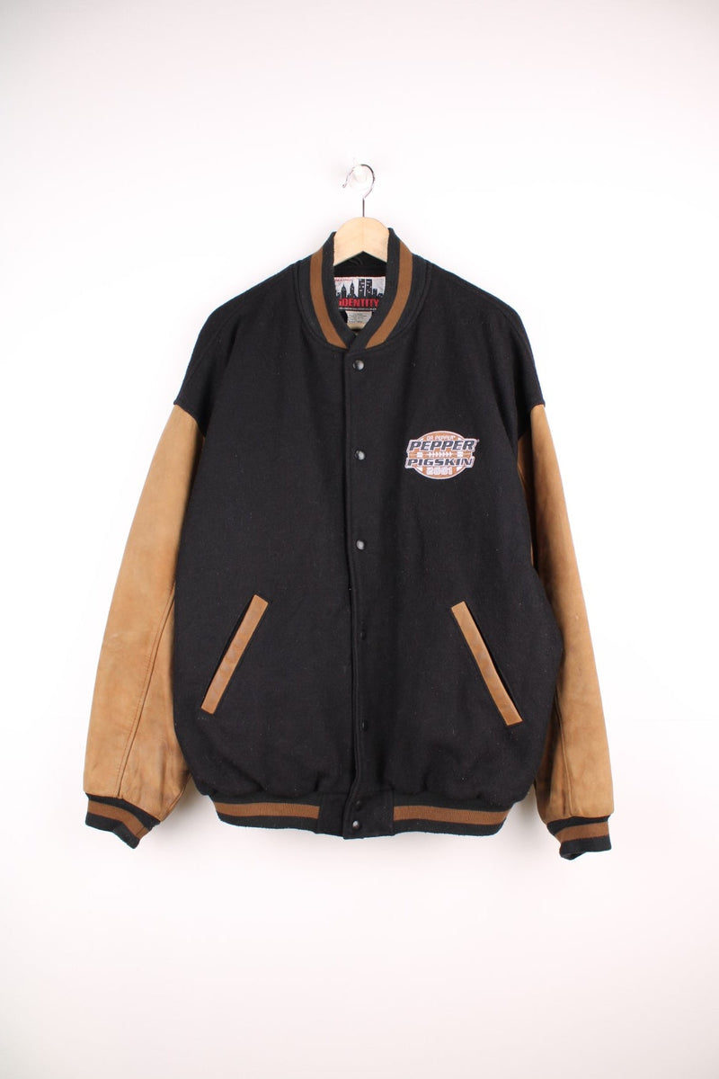 Vintage 2001 Dr Pepper, Pepper Pigskin black and brown leather varsity jacket by Identity. Features embroidered badge on the chest and popper fastenings. 