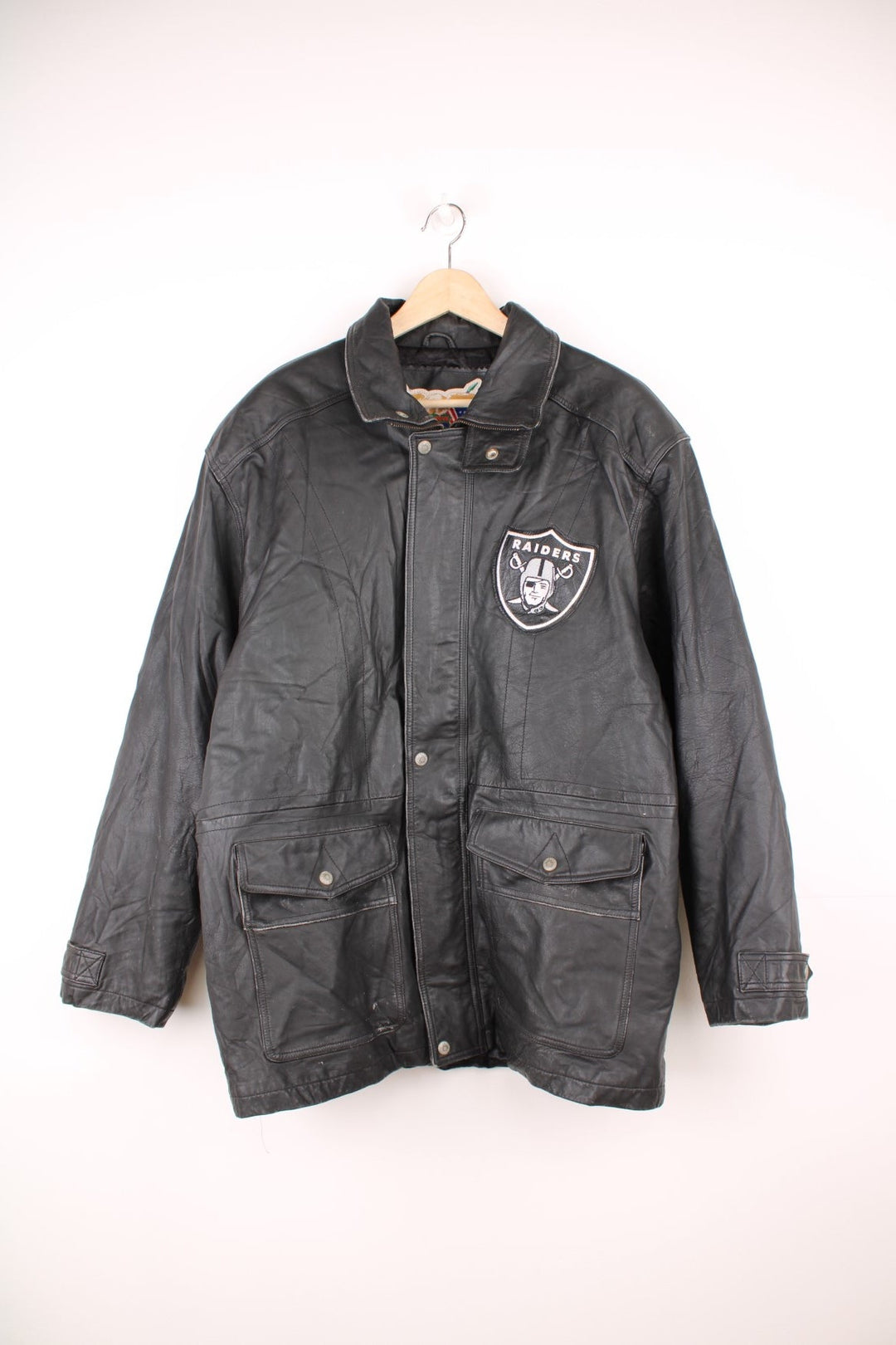 Vintage Oakland Raiders collared zip through leather jacket. Features embroidered badge on the front and back. 