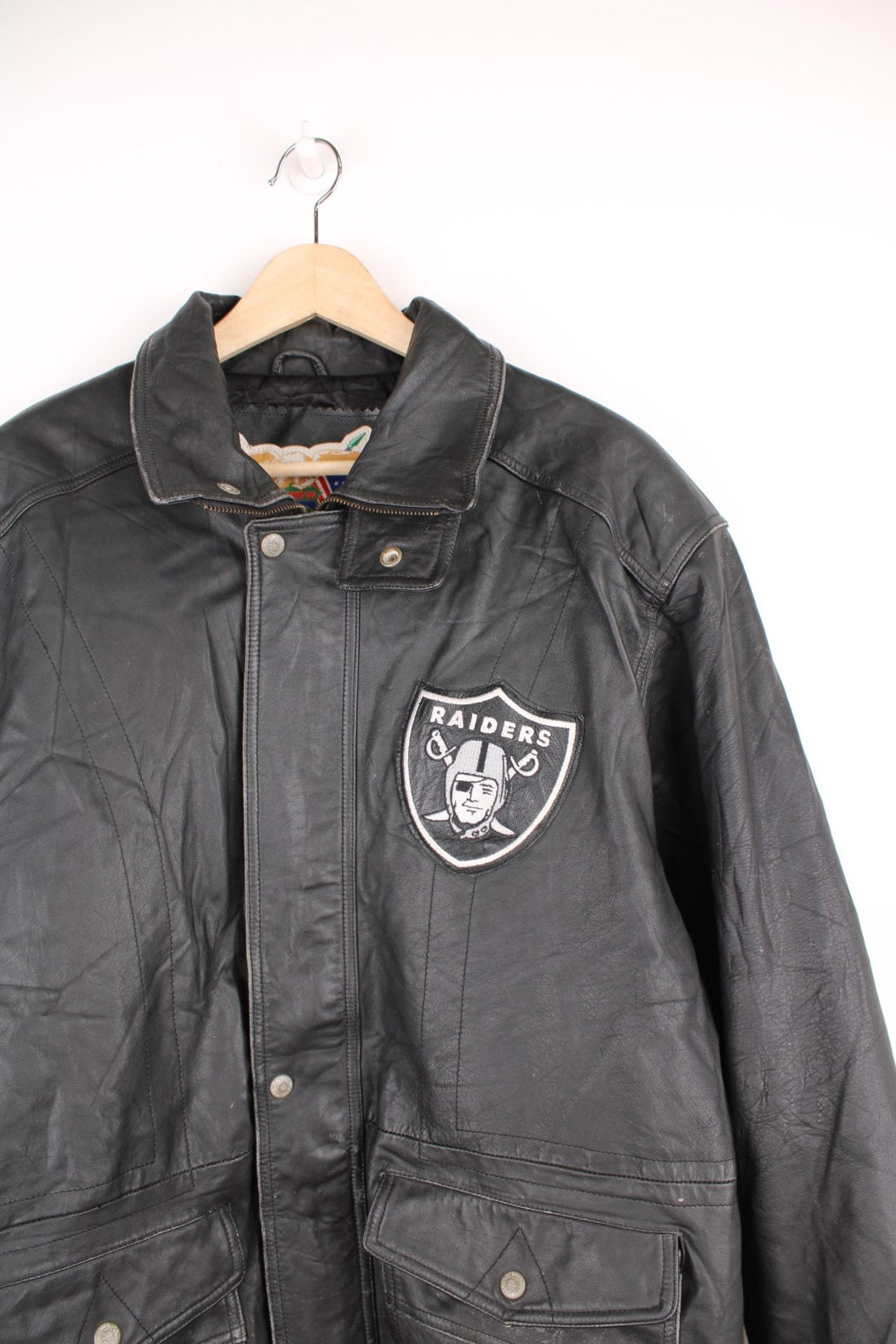 Vintage Oakland Raiders collared zip through leather jacket. Features embroidered badge on the front and back. 