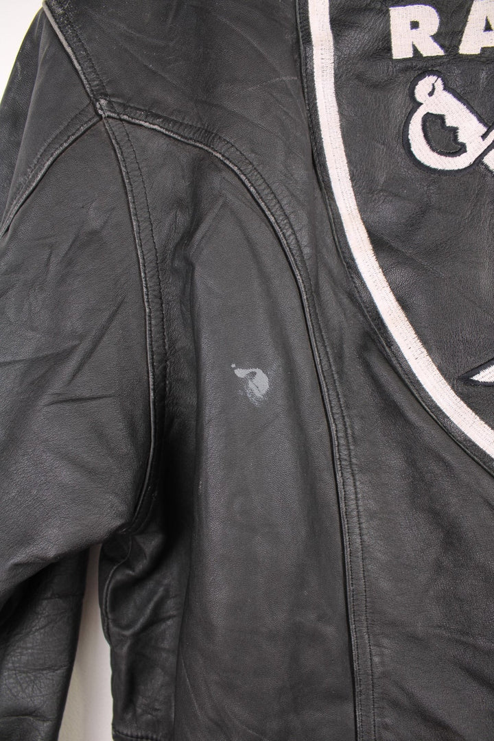 Vintage Oakland Raiders collared zip through leather jacket. Features embroidered badge on the front and back. 