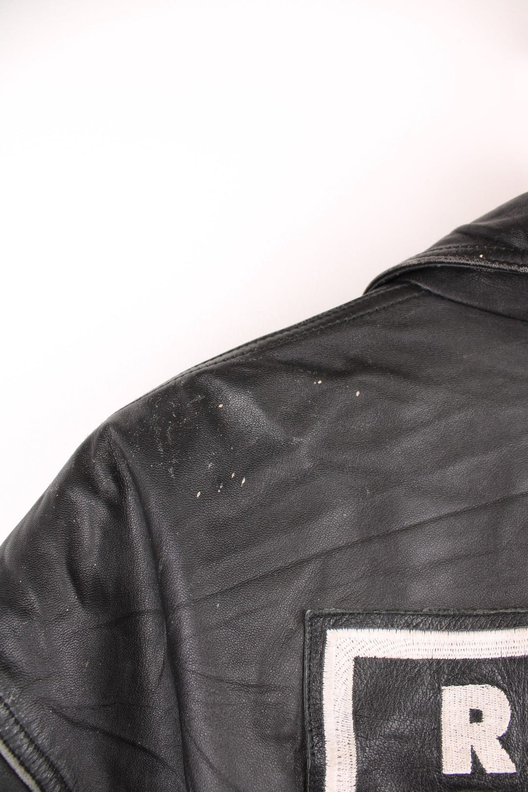 Vintage Oakland Raiders collared zip through leather jacket. Features embroidered badge on the front and back. 