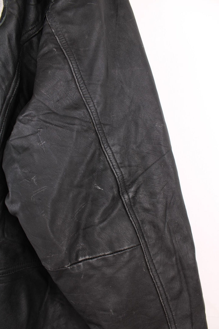 Vintage Oakland Raiders collared zip through leather jacket. Features embroidered badge on the front and back. 